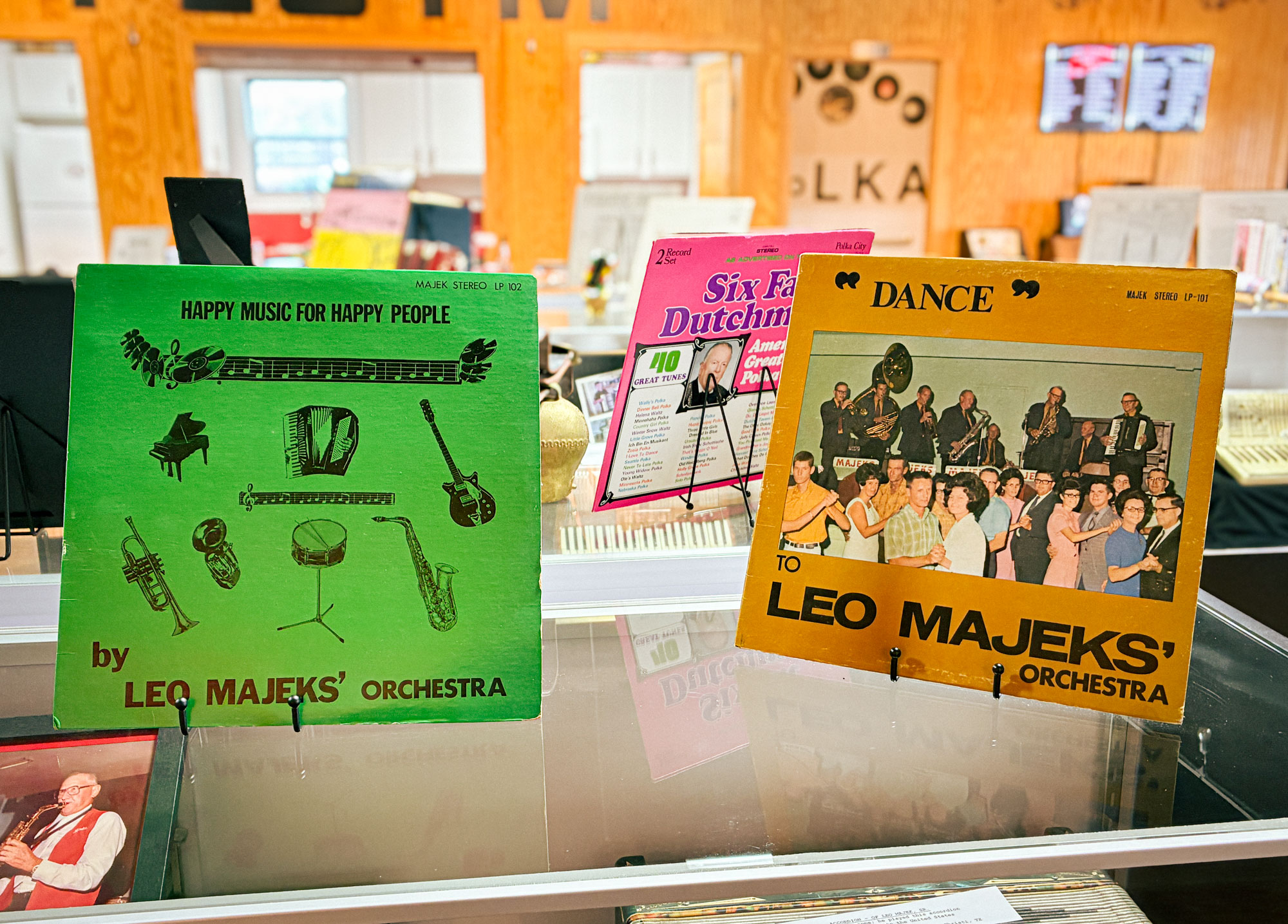 Two vinyl album covers by artist Leo Majeks sit on a display case.