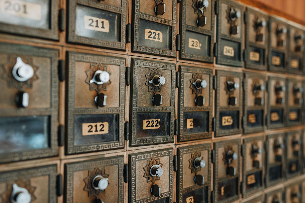 A large wall of post office boxes, with visible numbers of 201, 211, 221, 231, 241, 212, 222, and 242
