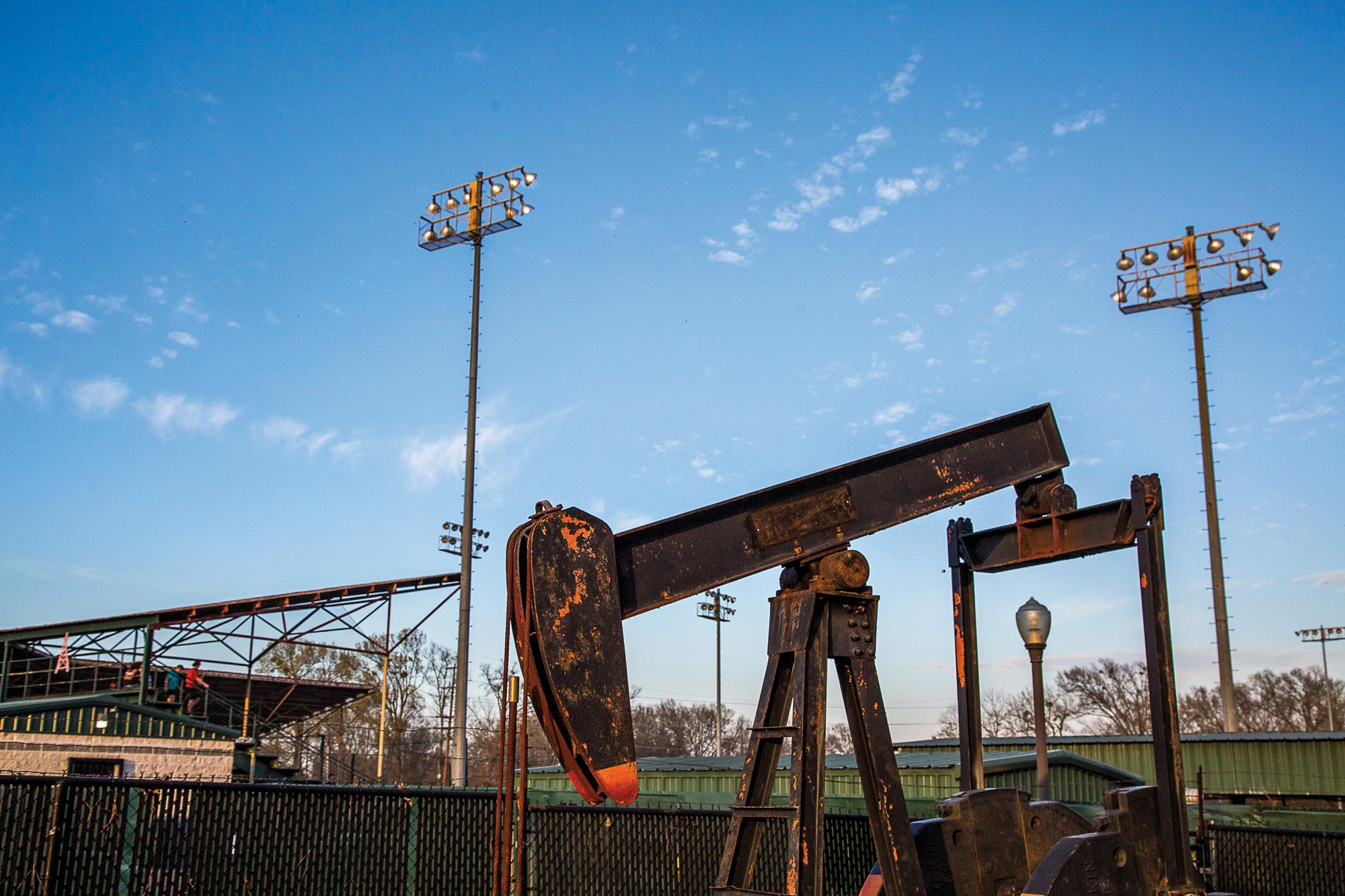 A pumpjack outside a baseball stadium