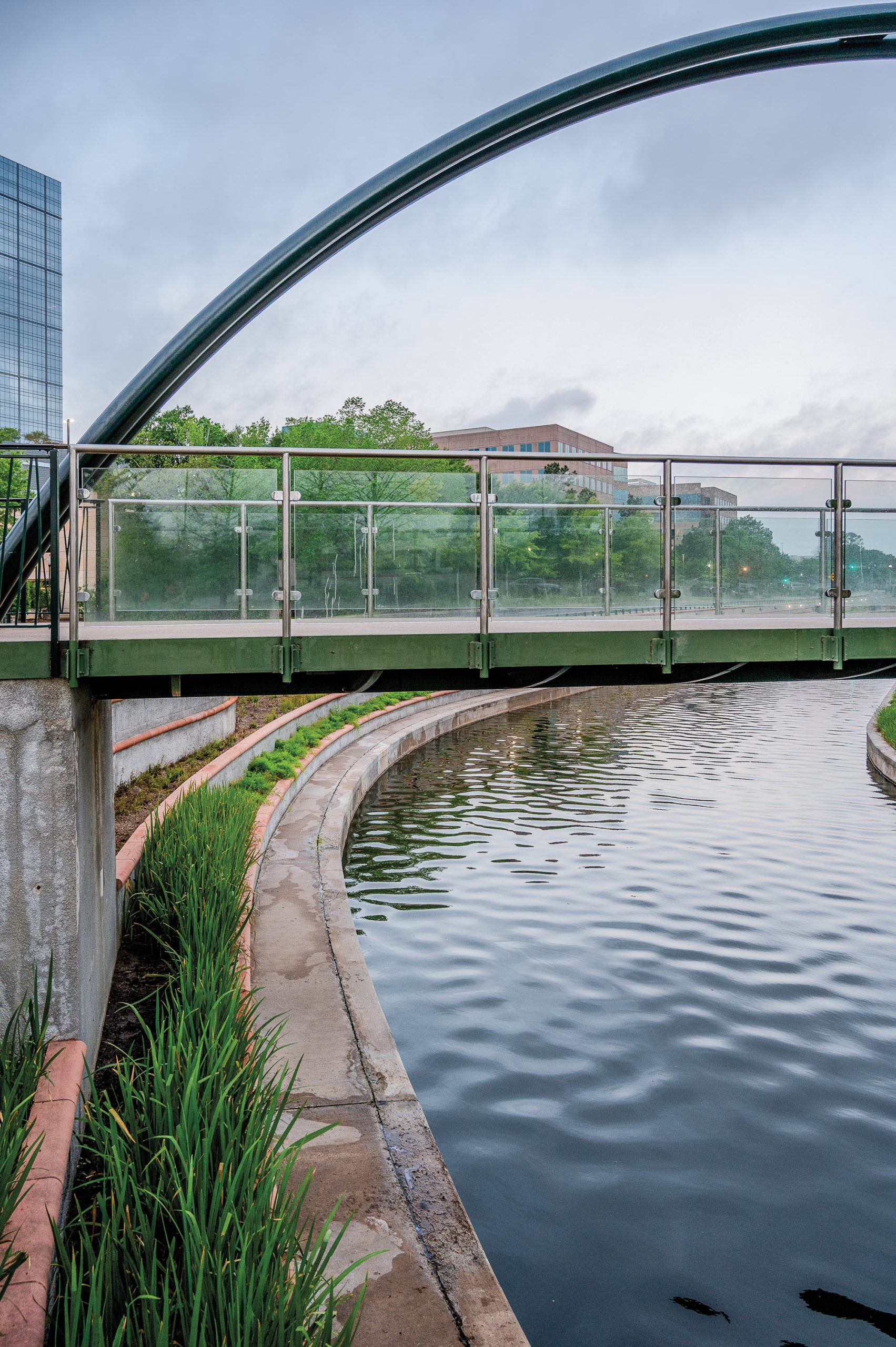 A bridge over a waterway with an arch above