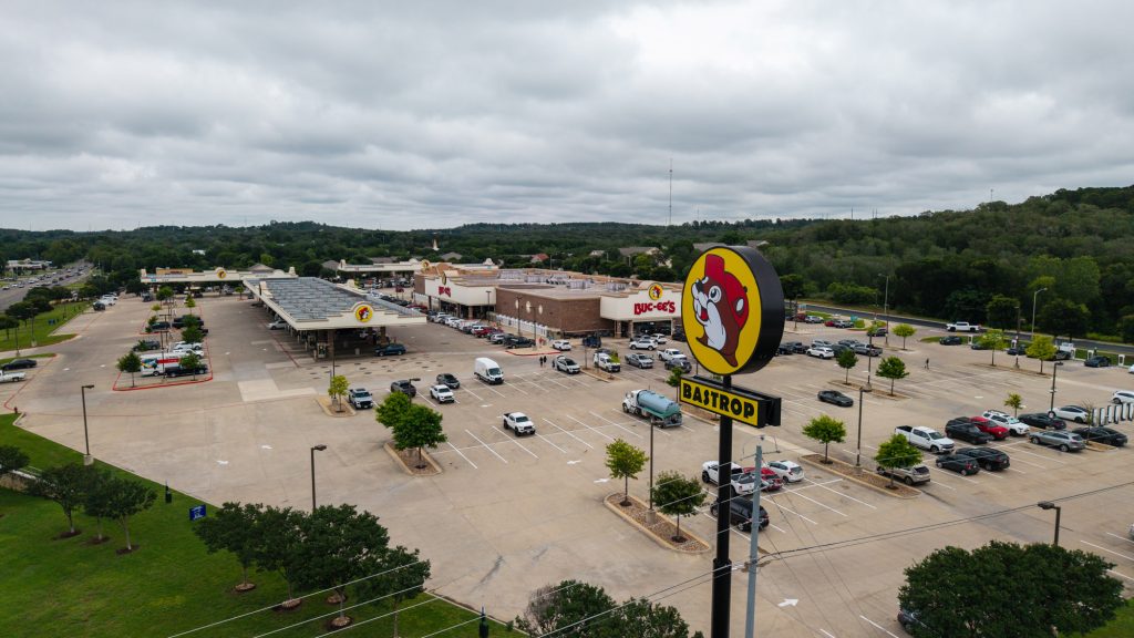 A large parking lot with a Buc-ee's sign and building