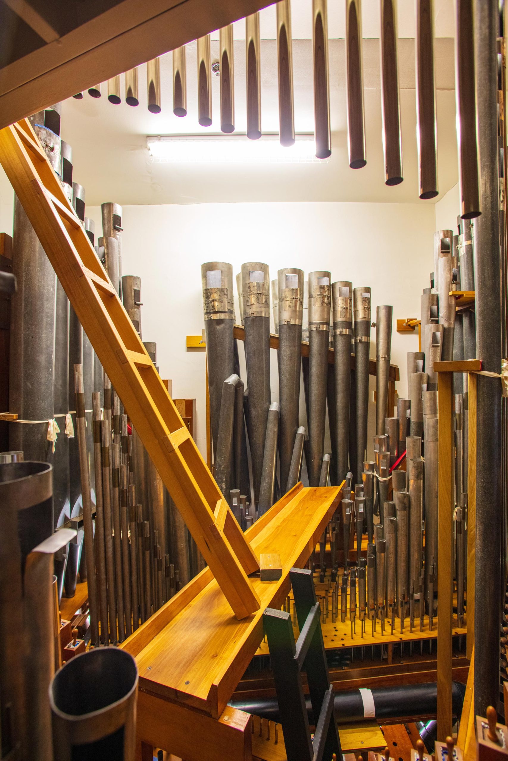 Metal pipes and wooden ladders inside a pipe organ