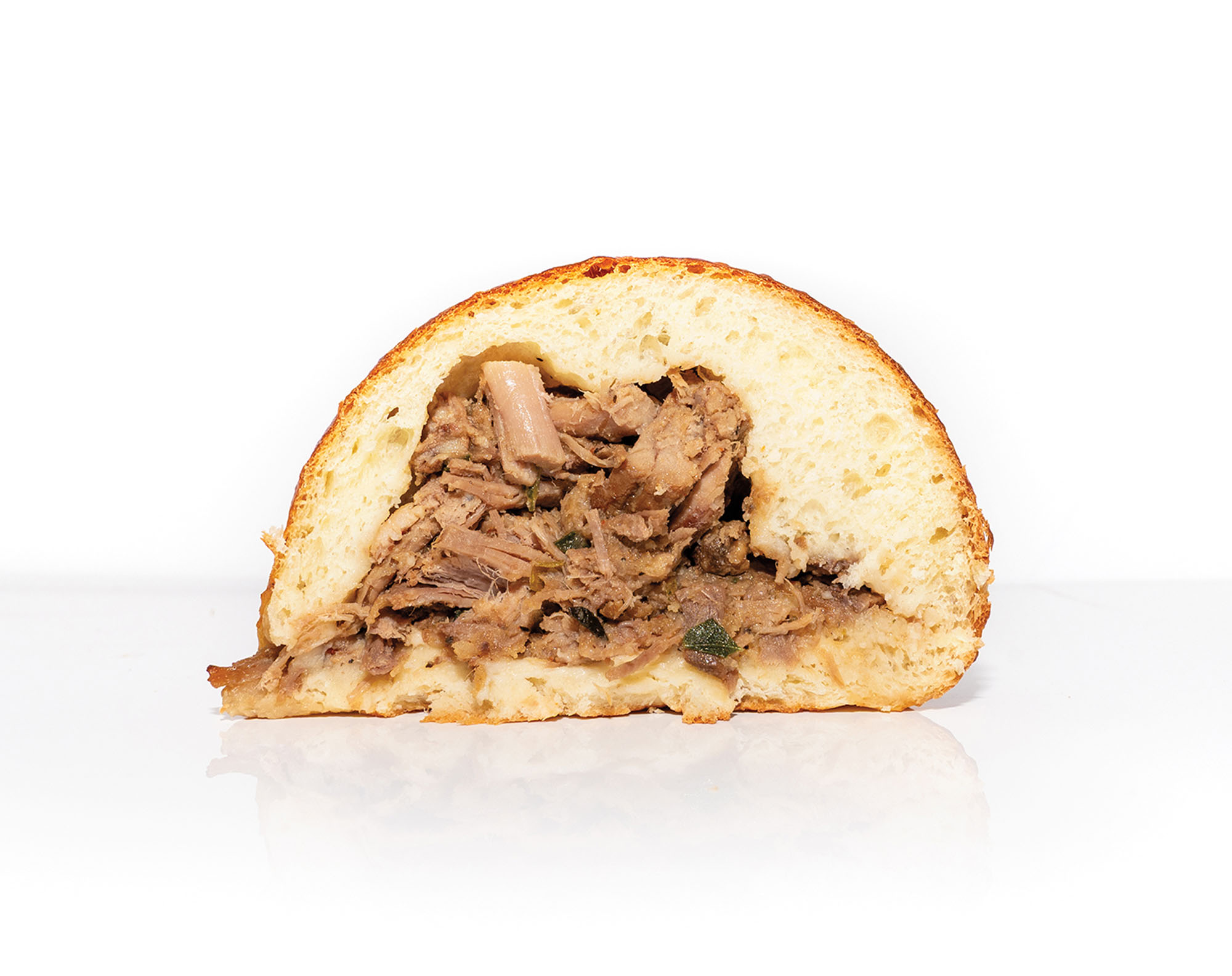 A kolache stuffed with pho beef cut in half.