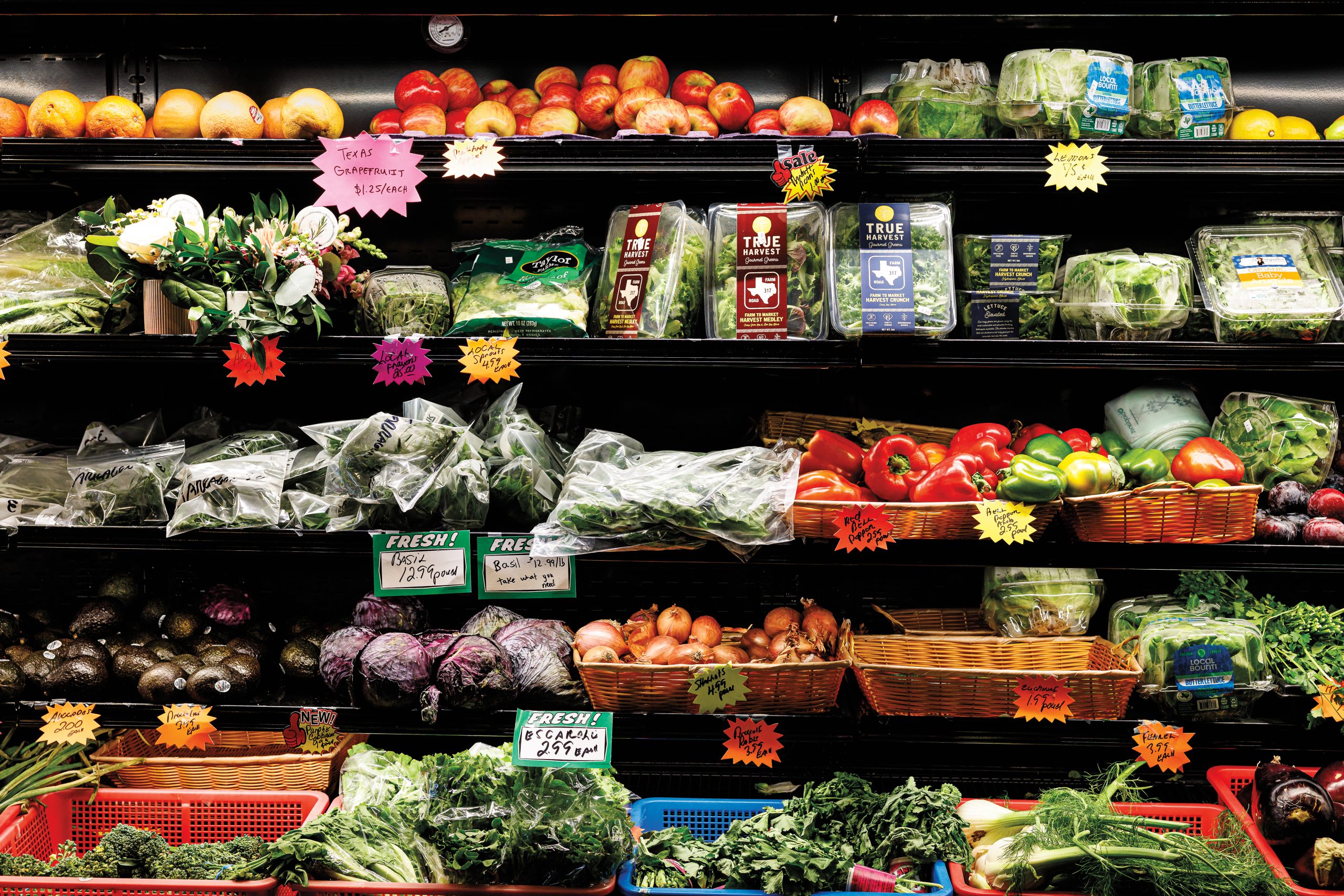 Grocery store shelves stocked with assorted produce
