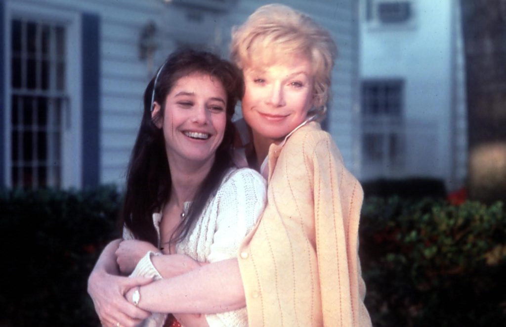 Two women, one blonde and one brunette, hugging