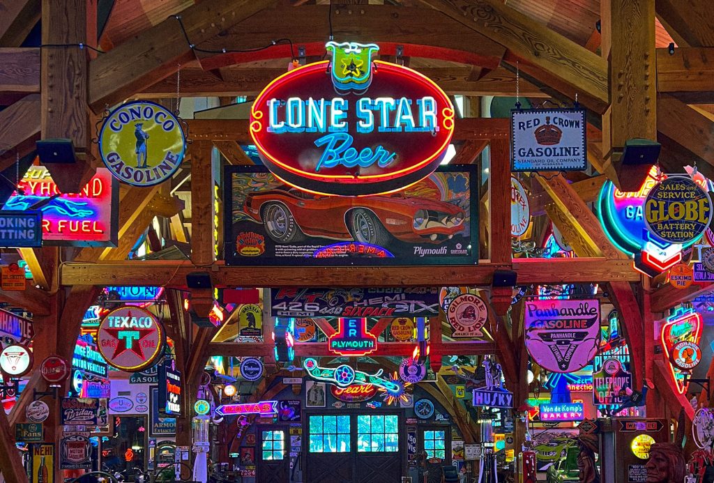 Hung from the rafters, a vintage "Lone Star Beer" sign is surrounded by other vintage neon and porcelain signs in Hemi Hideout.