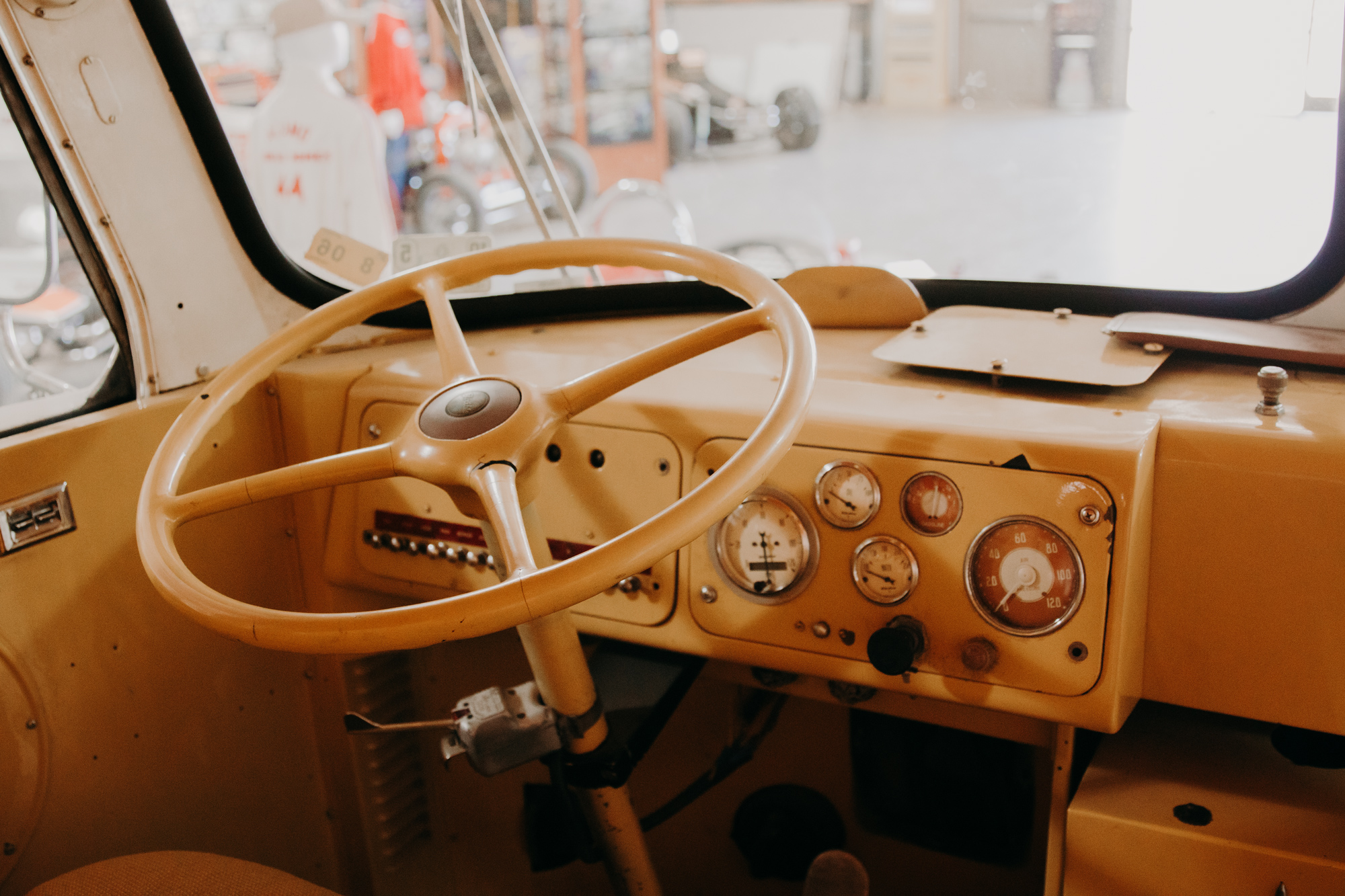 The steering wheel and dashboard of a retro RV