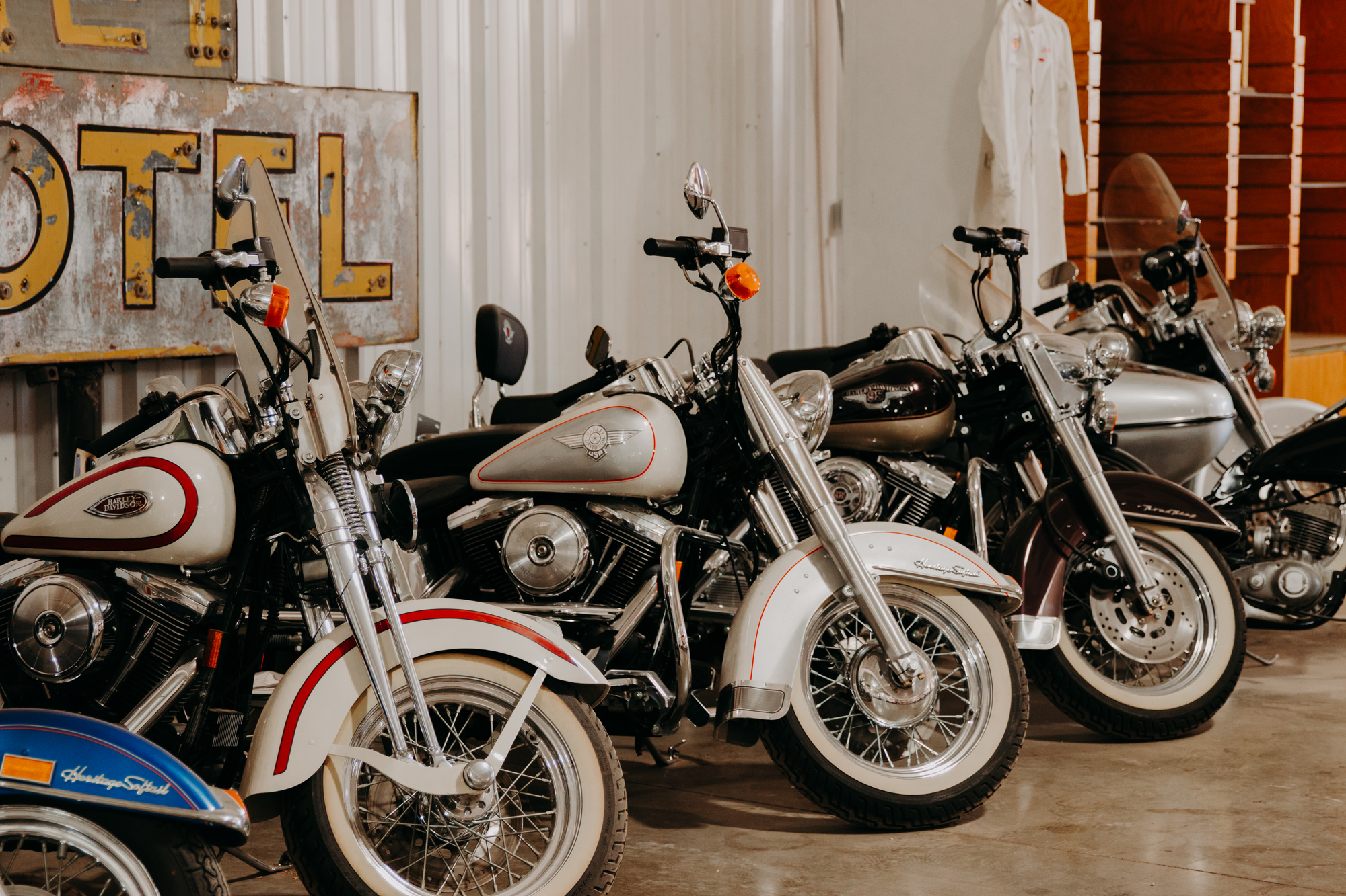 Four motorcycles lined up against a wall