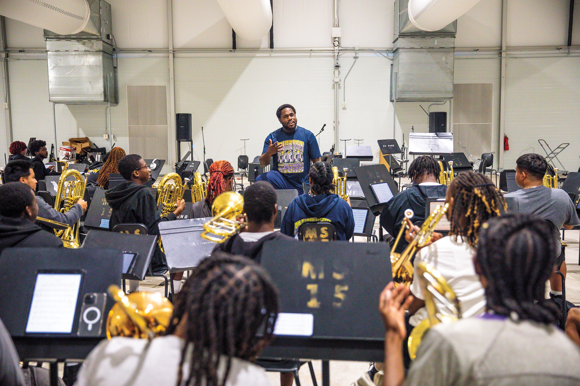 A band teacher addressing a classroom full of horn players