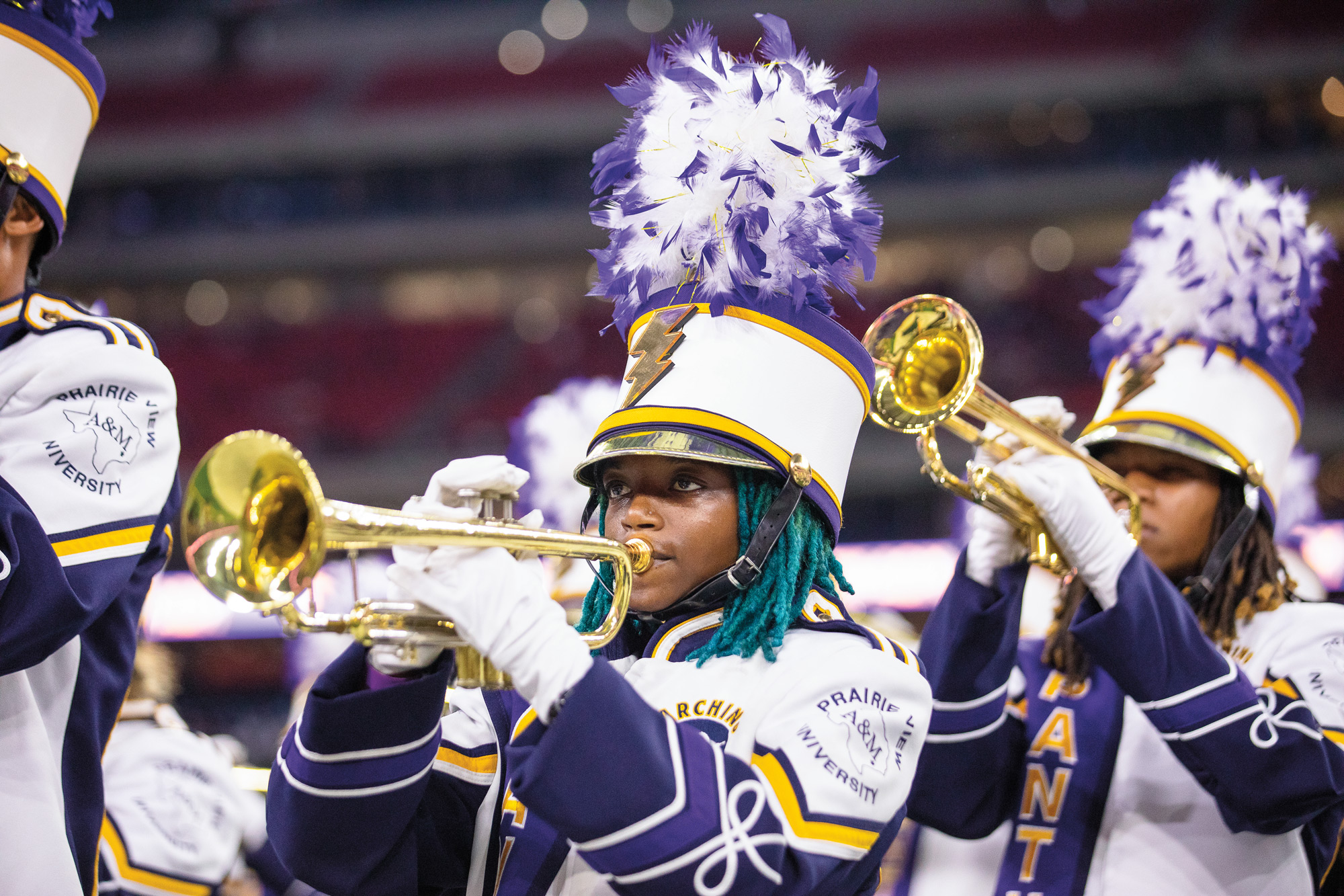 A marching band featuring trumpeters at the front