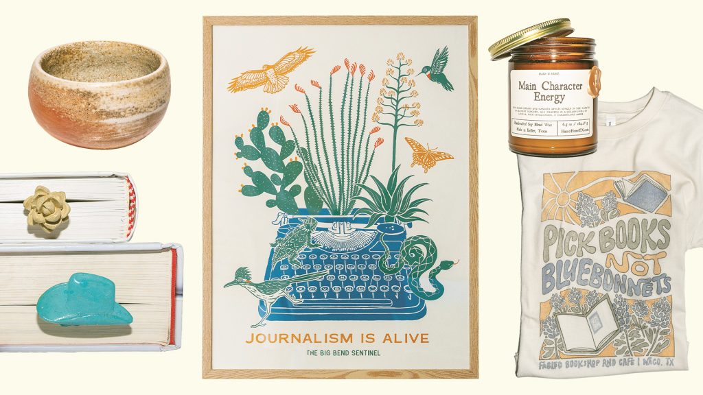 A brown bowl, a cowboy hat and yellow rose bookmarks, a framed print featuring a typewriter with animals and the words Journalism is Alive, a candle in a glass jar, and a beige shirt that reads Pick Books not Bluebonnets