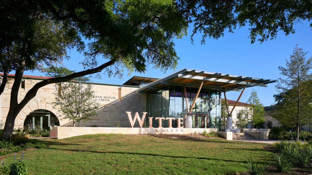 A light-colored stone building with a long metal awning and the words Witte Museum visible