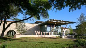 A light-colored stone building with a long metal awning and the words Witte Museum visible